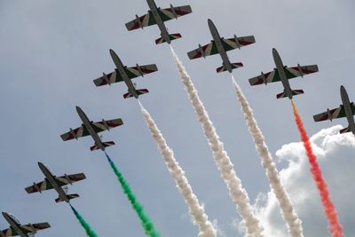 Low angle view of airshow against sky