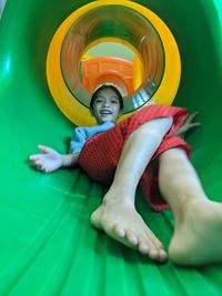 Full length of cute girl on slide at playground