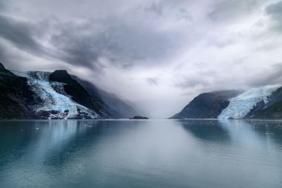 Scenic view of lake against sky during winter