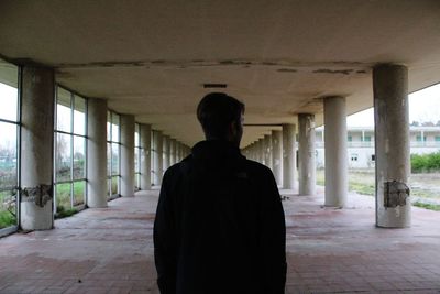 Rear view of man in an abandoned building