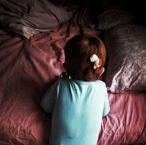 High angle view of baby sleeping in bed