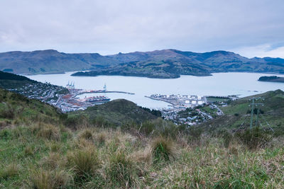 Scenic view of river and mountains against sky