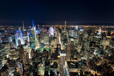 High angle view of illuminated cityscape against sky at night