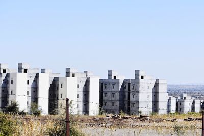 Buildings against clear blue sky