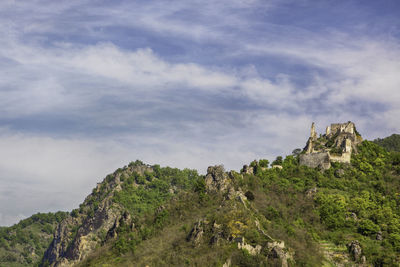 Scenic view of mountain against cloudy sky