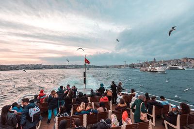 People enjoying in sea against sky