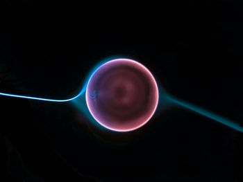 Close-up of illuminated lights over black background