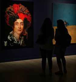 Rear view of women standing at music concert