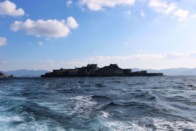 Scenic view of sea and buildings against sky