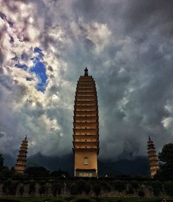 Buildings against cloudy sky