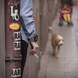 Low section of man with dog on street