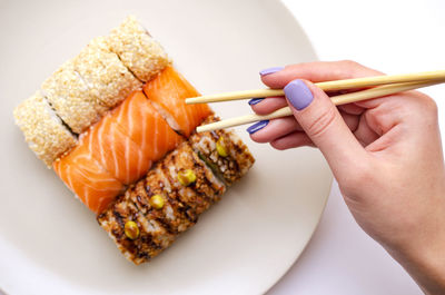 Cropped hand of person holding food