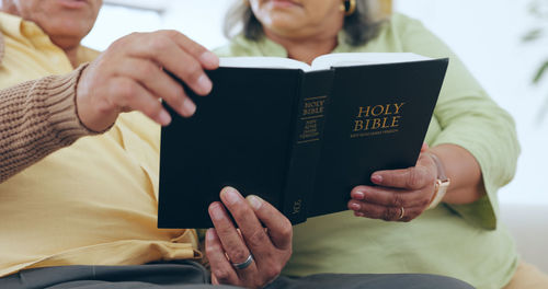 Midsection of woman holding book