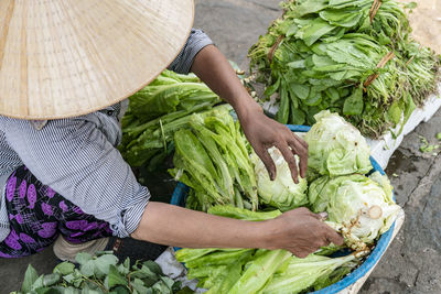 High angle view of woman holding vegetables at market