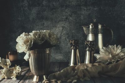 Close-up of roses in glass on table