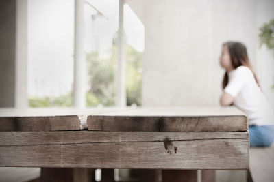 Woman sitting on wooden floor