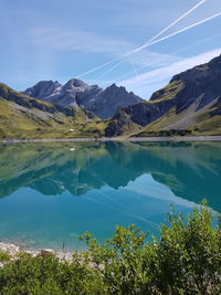 Scenic view of lake and mountains against sky