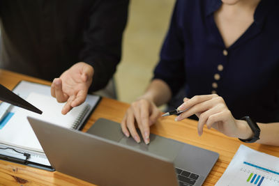Midsection of businessman working at office