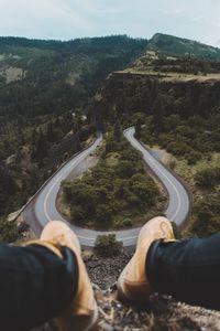 Low section of man on mountain road