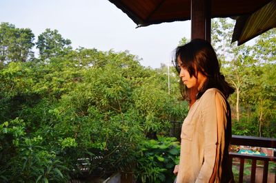 Woman standing by plants