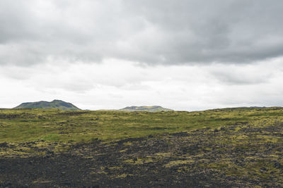 Vast land covered with gravel and moss in iceland on cloudy day