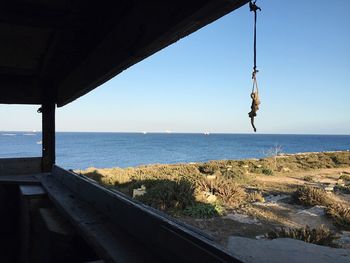 Calm blue sea against clear sky