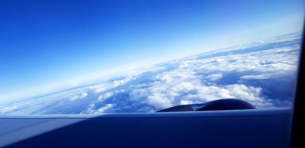 Close-up of airplane wing against sky