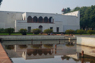 Built structure by lake against sky