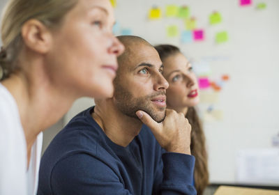 Business people looking away in creative office