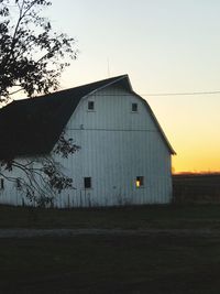 Barn on field against clear sky