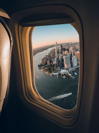 Aerial view of cityscape seen through airplane window