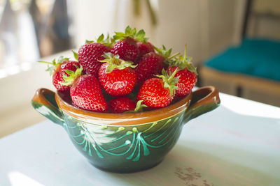 Bowl of strawberries on table