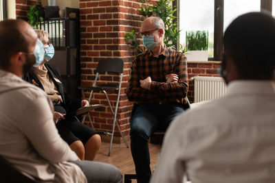 People wearing mask having discussion