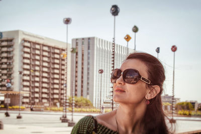 Portrait of man in city against sky