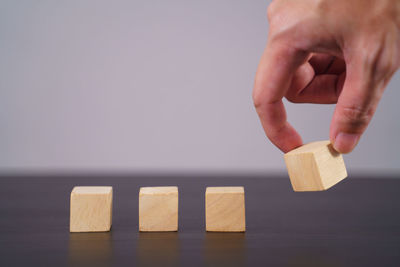 Close-up of hand holding toy on table