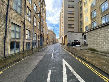 View along, scoresby street, with victorian buildings, on a wet day in, little germany, bradford, uk