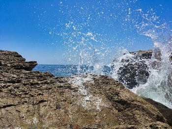 Sea waves splashing on rocks