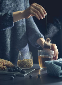 Midsection of man preparing food in jar