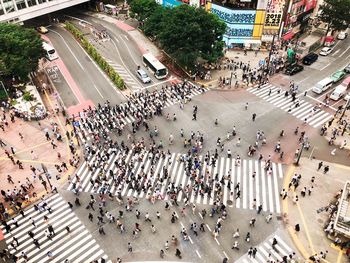 High angle view of people crossing road in city