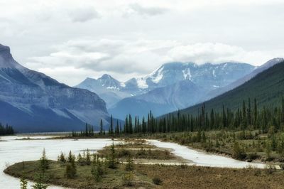 Scenic view of lake and mountains against sky