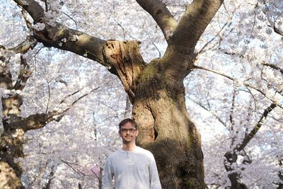 Low angle view of woman standing on tree