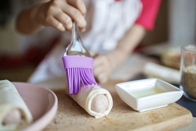 Midsection of girl preparing food on cutting board