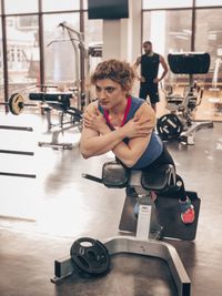 Side view of woman exercising in gym