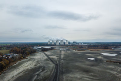 View of factory against cloudy sky