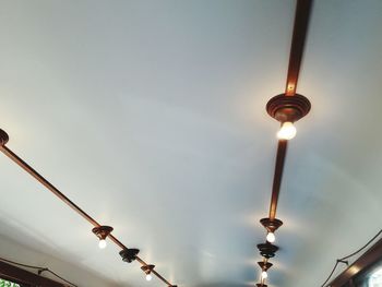 Low angle view of illuminated street light against sky