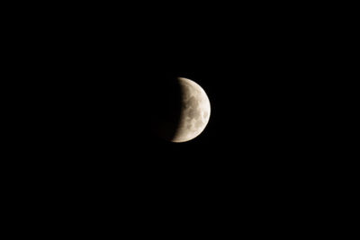 Low angle view of half moon against sky at night