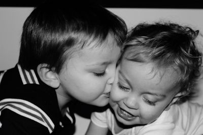 Close-up of boy kissing brother