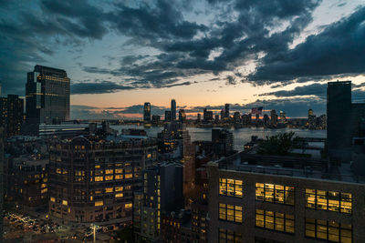 High angle view of illuminated buildings against sky at sunset