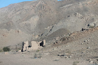 People on mountain against sky