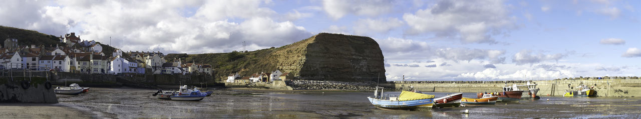 Boats in sea at low tide 